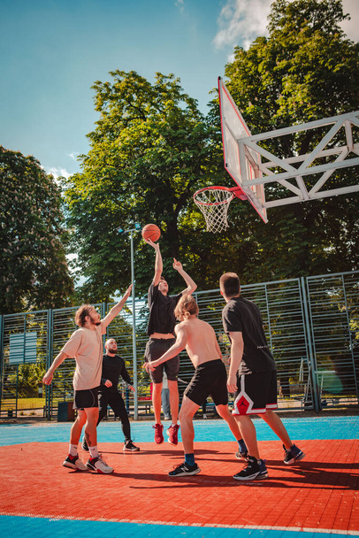 ウクライナのリヴィウ-2022年5月28日:男性は屋外で夏の晴れた日にバスケットボールをプレイ - 写真・画像