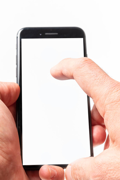 Man hand using smartphone on white background. Closeup shot of man hand holding a smartphone. Vertical image - Foto, afbeelding