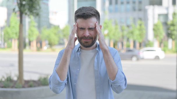 Outdoor Portrait of Man having Headache - Фото, изображение