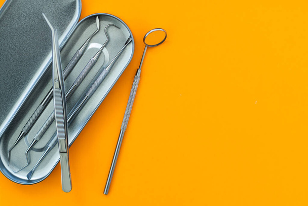 Dentist tools. Teethcare, dental health concept. orange background top view copy space. - Photo, Image