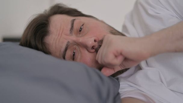 Portrait of Beard Young Man Coughing while Sleeping in Bed - Fotó, kép