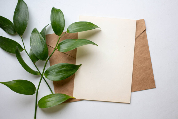 mockup card with plants. invitation card with environment and details Mockup with postcard and flowers on white background. - Photo, Image