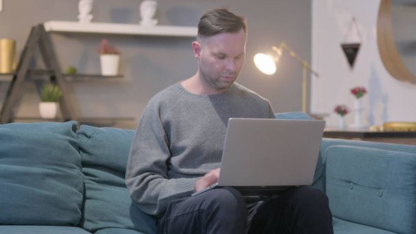 Middle Aged Man Using Laptop while Sitting at Home - Photo, Image
