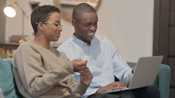 The Young Couple having Successful Online Shopping on Laptop on Sofa - Photo, image