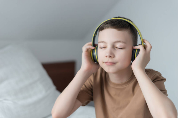 happy kid listen audio song with earphones and relax at home - Zdjęcie, obraz