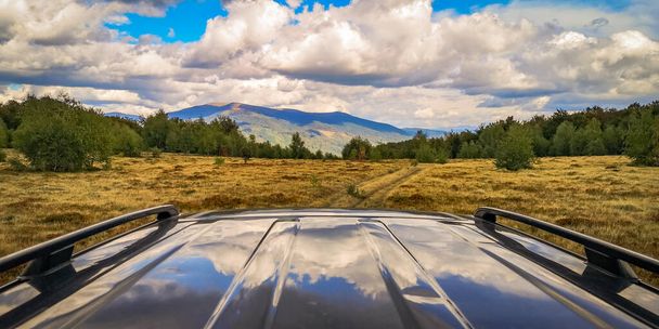 Autumn landscape in the Carpathian countryside with SUV - Фото, изображение
