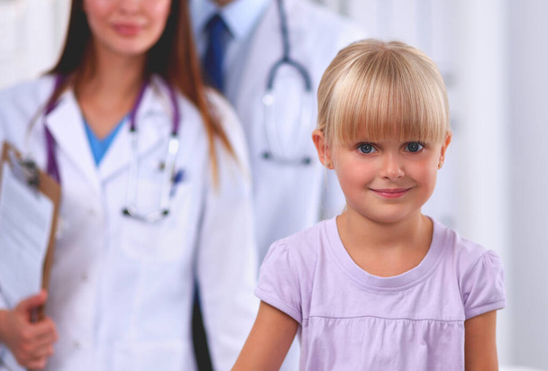 Little girl and young doctor in hospital having examination, isolated - Foto, imagen