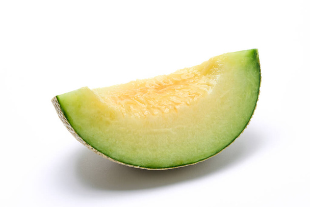 Earl's melon cut in quarters, photographed against a white background - Fotoğraf, Görsel