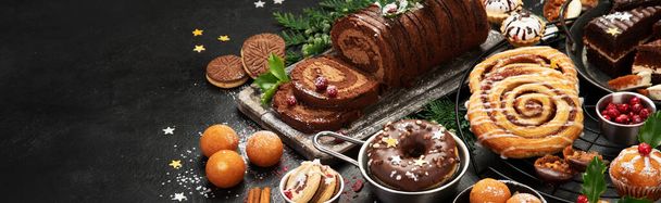 Traditional Christmas dessert on dark background. Holiday food. copy space, panorama - Foto, imagen
