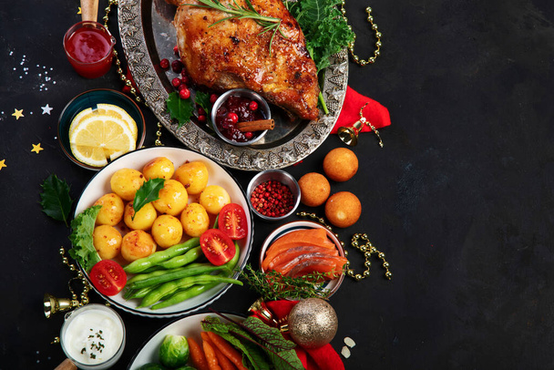 Traditional Christmas dinner on dark background. Holiday food. Top view, copy space - Fotografie, Obrázek