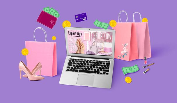 Laptop, bags, credit card and money on violet background. Online shopping concept - Zdjęcie, obraz