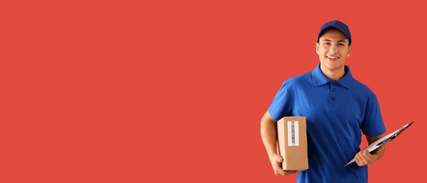 Delivery man with box and clipboard on red background with space for text - Foto, imagen