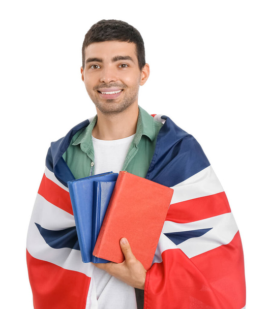 Young man with UK flag and books on white background - Фото, зображення