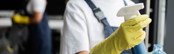 partial view of blurred cleaner in rubber glove holding detergent, banner - Fotografie, Obrázek