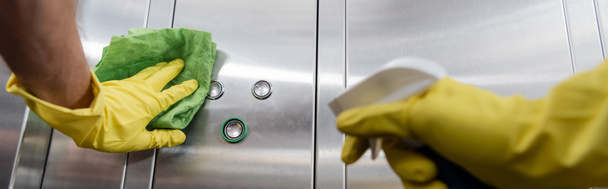 partial view of man in rubber gloves cleaning office elevator with rag, banner - Foto, afbeelding
