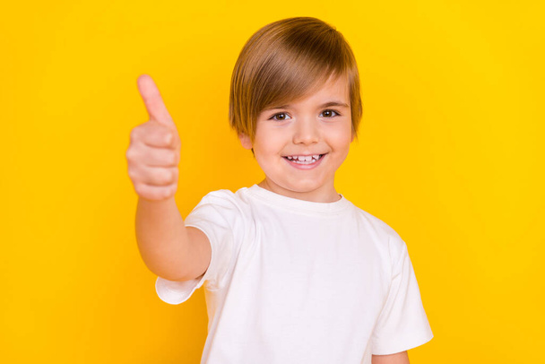Portrait of attractive lucky cheerful pre-teen boy showing giving thumbup agree ad isolated over bright yellow color background. - Fotoğraf, Görsel
