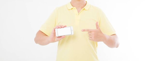 man in t-shirt shirt holding and pointing on blank screen mobile phone isolated on white background. Arm hold smartphone, copy space - Foto, afbeelding