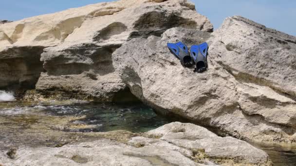 Flippers on the rocky seashore. Caspian Sea. 07 June 2022 Year. - Filmmaterial, Video