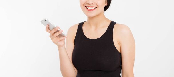 smiling woman hold cellphone. Closeup young happy beautiful asian japanese woman. Girl looking at mobile cellphone isolated on white background. Positive face expression human emotion. Copy space. - Photo, Image