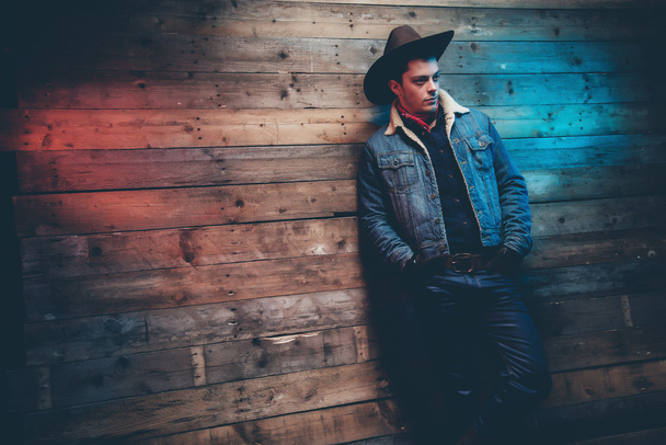 Winter cowboy jeans fashion man. Wearing brown hat, jeans jacket - Photo, Image