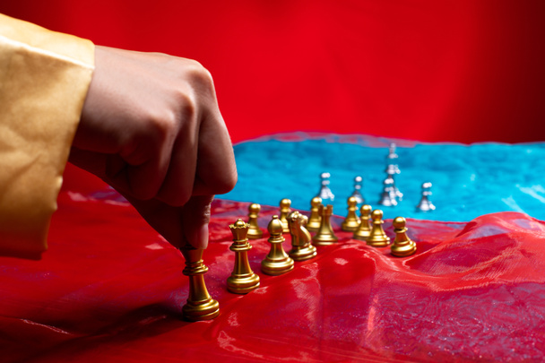 Chess on Red Blue Fabric as abstract of USA, China, Taiwan Crisis Map. Military move force sanction to stop trade chip technology on Taiwan. Invasion Threat is game tension international. copy space - Photo, image