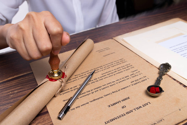 Lastwill Inheritance document Contract is approved by Lawyer to seal wax and stamp approval to finance and separate asset by justice law notary. They allocate insurance money real estate. copy space - Valokuva, kuva