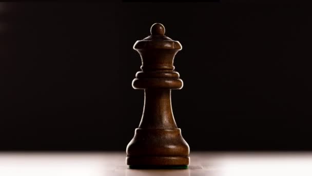 Close up of individual chess pieces against black background - Video