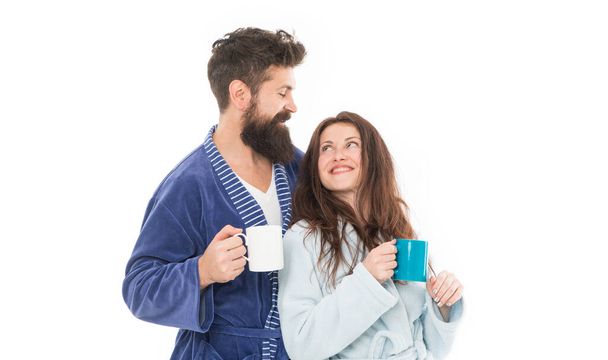 family day at home. Couple enjoy lazy weekend and drink coffee. man and woman need relax and energy. everyday routine. good morning coffee. happy family drink tea. couple in love wear bathrobe. - Foto, afbeelding