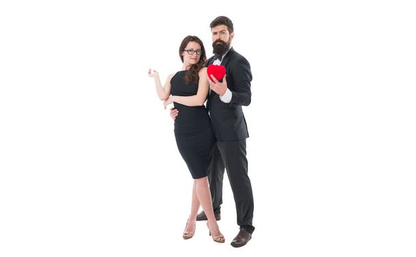 Share sincere feelings. True love concept. Happy couple in love formal outfit black dress white background. Make her happy. Happy valentines day. Hipster giving red heart love symbol. Happy together. - Фото, зображення