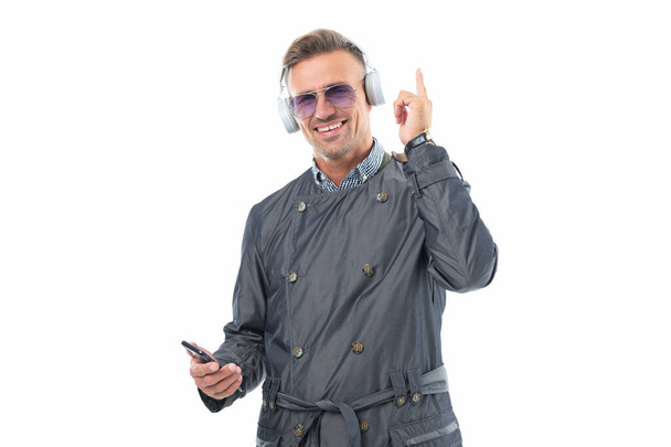 Happy man listening to music pointing finger up. Music player in smartphone. Mobile music. - Foto, Imagem