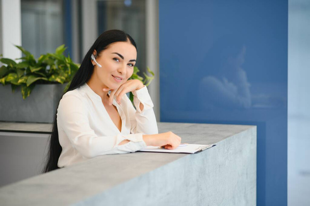 Picture of pretty receptionist at work - Фото, изображение