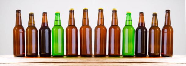 Beer bottles on a wooden table . Top view. Selective focus. Mock up. Copy space.Template. Blank. - Photo, Image