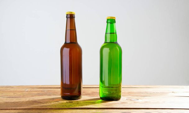 Beer bottles on a wooden table . Top view. Selective focus. Mock up. Copy space.Template. Blank. - Fotó, kép