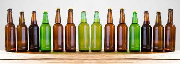 Beer bottles on a wooden table . Top view. Selective focus. Mock up. Copy space.Template. Blank. - Photo, Image