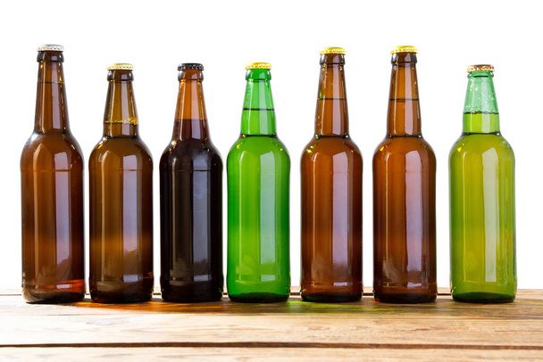 Beer bottles on a wooden table . Top view. Selective focus. Mock up. Copy space.Template. Blank. - Фото, зображення