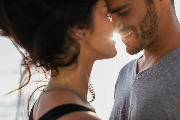 portrait of bearded man and brunette woman with closed eyes smiling outside  - Photo, Image