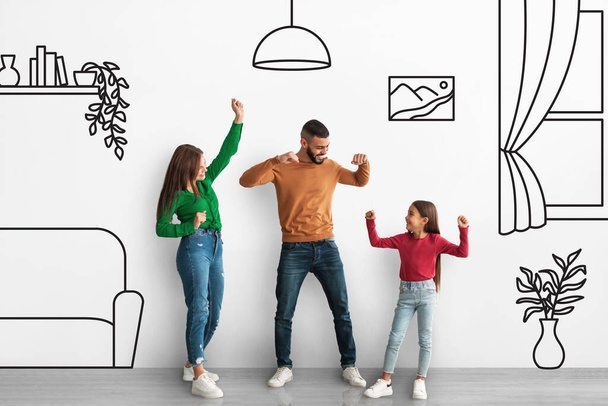 Happy mixed race family father, mother and little daughter having fun, dancing over interior sketch, moving to new apartment, celebrating relocation, full length shot, collage - Фото, изображение