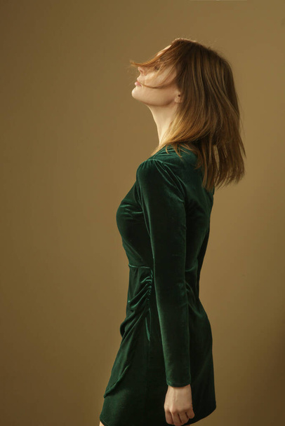 Serie of studio photos of young female model in emerald green plush mini dress, autumn winter fashion collection. - 写真・画像