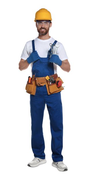 Professional builder in uniform with tool belt isolated on white - Valokuva, kuva