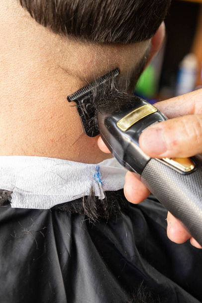 details of a shaver to design a modern haircut, work in a barbershop, body care, beauty and style - Photo, Image