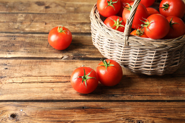 Fresh ripe red tomatoes on wooden table - Фото, изображение
