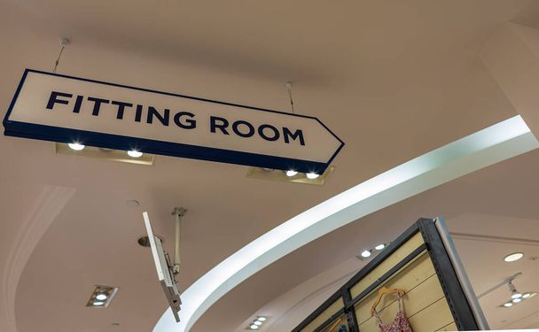 To the fitting rooms. Fitting Room Sign in the mall store shop retail clothing. Nobody, selective focus - Fotografie, Obrázek