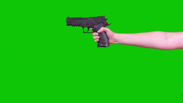 A Woman Holds A Pneumatic Pistol On A Green Screen In Her Hand. High quality 4k footage - Video