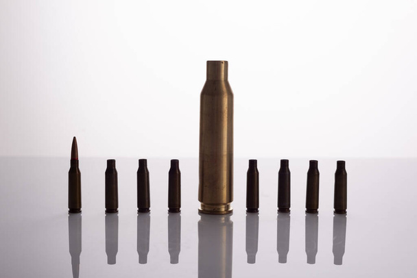 used spent shells of cartridges from a machine gun and a machine gun on a white background. - Foto, immagini