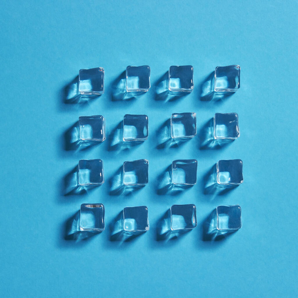Ice cubes on blue background - 写真・画像