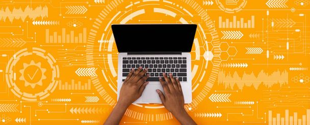 Young black man typing on laptop keyboard with blank screen on orange background with abstract symbols, collage, panorama. Networking, internet service, technology, modern tech, work and education - Foto, Bild
