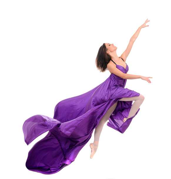 jumping girl dancer in flying purple dress - Foto, afbeelding