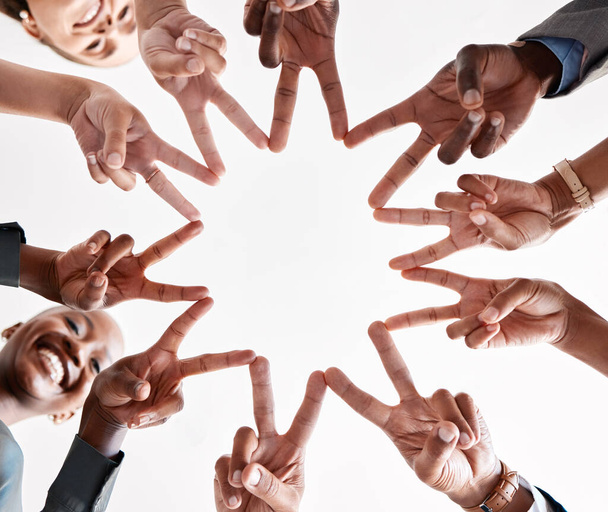 Teamwork, collaboration and star hand sign of business people for goal, mission and achievement success. Group diversity hands together with v sign or peace symbol for unity, trust and support below. - Zdjęcie, obraz