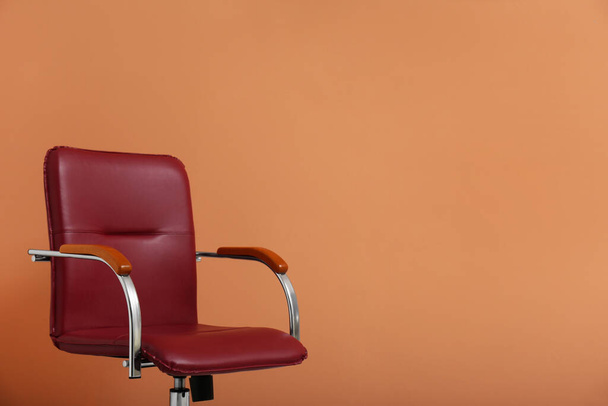 Modern office chair on orange coral background. Space for text - Фото, зображення