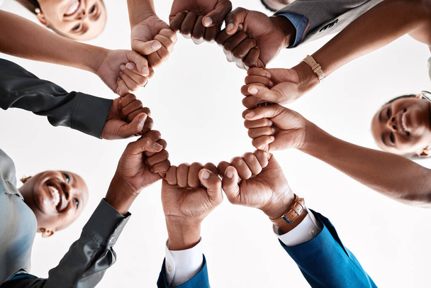 Hands, collaboration and motivation with a business team in a huddle with fists and a mindset of company vision. Mission, teamwork and goal with a group in a circle ready for growth and development. - Foto, Imagen